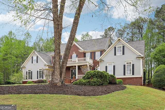 view of front of home with brick siding and a front lawn