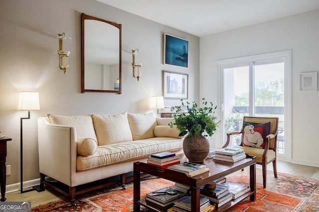 587 Virginia Ave NE Unit 314, Atlanta, GA 30306 - living room featuring baseboards and light wood finished floors