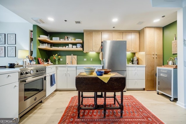 587 Virginia Ave NE Unit 314, Atlanta, GA 30306 - kitchen with stainless steel appliances, open shelves, light wood-type flooring, visible vents, and light countertops