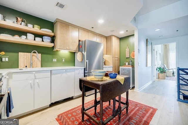 587 Virginia Ave NE Unit 314, Atlanta, GA 30306 - kitchen with a sink, white dishwasher, light wood-style flooring, and visible vents