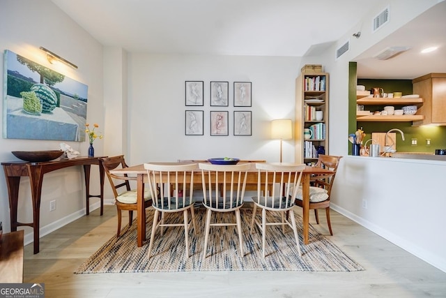 587 Virginia Ave NE Unit 314, Atlanta, GA 30306 - dining space featuring baseboards, visible vents, and light wood-style flooring