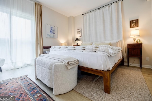 587 Virginia Ave NE Unit 314, Atlanta, GA 30306 - bedroom featuring baseboards and wood finished floors