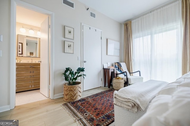 587 Virginia Ave NE Unit 314, Atlanta, GA 30306 - bedroom featuring light wood-style floors, baseboards, and visible vents