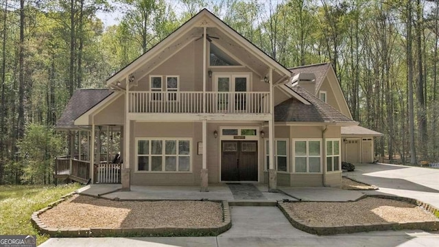 3800 Macland Rd, Hiram, GA 30141 - view of front of property with a balcony, driveway, a porch, roof with shingles, and stucco siding