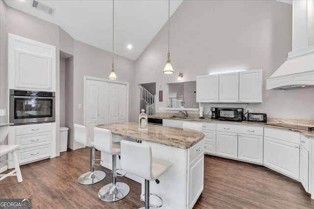 3800 Macland Rd, Hiram, GA 30141 - kitchen featuring black appliances, high vaulted ceiling, white cabinetry, a breakfast bar area, and light stone countertops