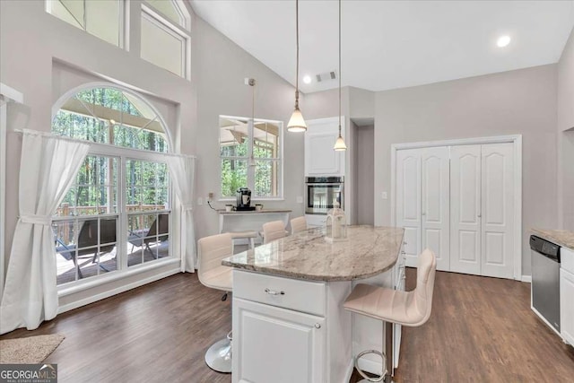 3800 Macland Rd, Hiram, GA 30141 - kitchen featuring appliances with stainless steel finishes, dark wood-style flooring, high vaulted ceiling, white cabinetry, and light stone counters