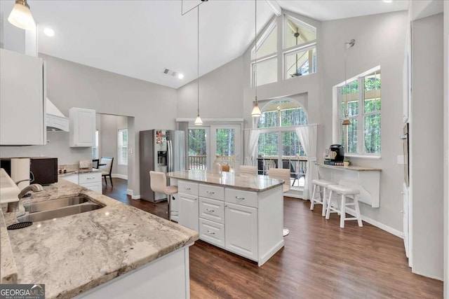 3800 Macland Rd, Hiram, GA 30141 - kitchen featuring stainless steel fridge with ice dispenser, white cabinetry, dark wood finished floors, a center island, and high vaulted ceiling