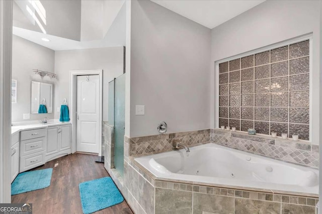3800 Macland Rd, Hiram, GA 30141 - bathroom featuring vanity, a stall shower, a jetted tub, and wood finished floors