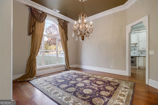1418 Brighton Pl, Loganville, GA 30052 - dining area with a chandelier, healthy amount of natural light, wood finished floors, baseboards, and ornamental molding