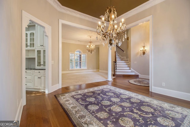 1418 Brighton Pl, Loganville, GA 30052 - foyer entrance featuring ornamental molding, a chandelier, wood finished floors, stairs, and baseboards