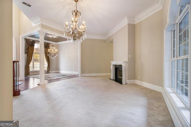1418 Brighton Pl, Loganville, GA 30052 - unfurnished living room featuring a chandelier, ornamental molding, carpet floors, decorative columns, and a premium fireplace
