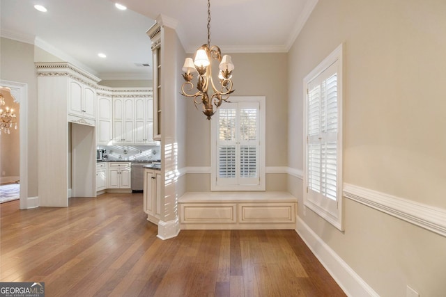 1418 Brighton Pl, Loganville, GA 30052 - unfurnished dining area featuring a chandelier, hardwood / wood-style flooring, healthy amount of natural light, crown molding, and baseboards