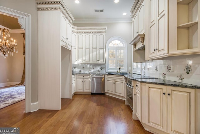1418 Brighton Pl, Loganville, GA 30052 - kitchen featuring appliances with stainless steel finishes, crown molding, backsplash, dark wood-style floors, and a chandelier