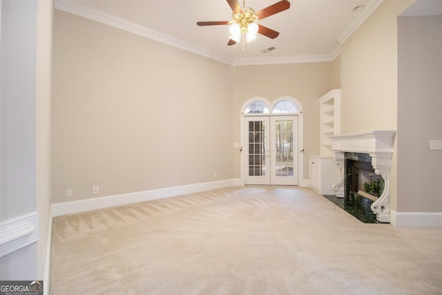1418 Brighton Pl, Loganville, GA 30052 - unfurnished living room featuring carpet floors, ornamental molding, a high end fireplace, ceiling fan, and french doors