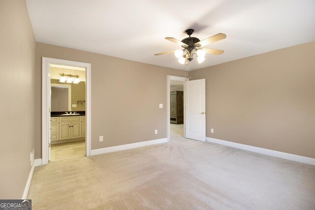 1418 Brighton Pl, Loganville, GA 30052 - unfurnished bedroom featuring light colored carpet, baseboards, a sink, and ensuite bath