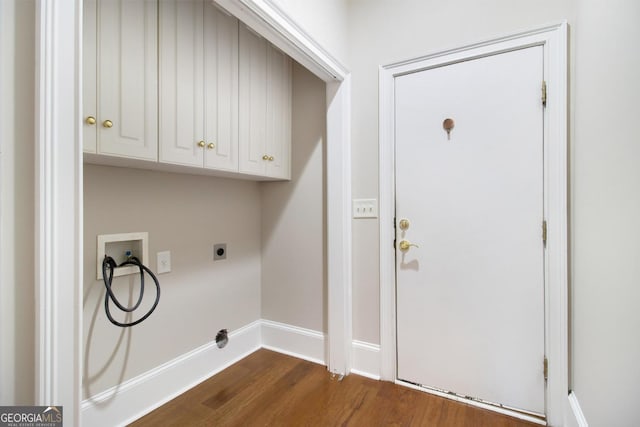 1418 Brighton Pl, Loganville, GA 30052 - laundry area featuring cabinet space, washer hookup, dark wood-type flooring, and baseboards