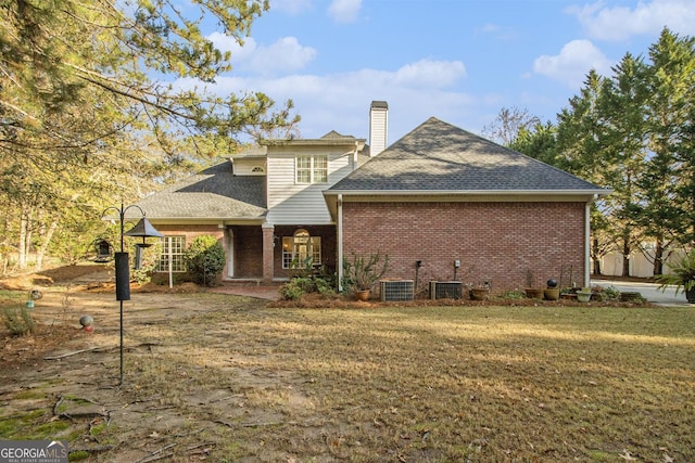 1418 Brighton Pl, Loganville, GA 30052 - back of property featuring a chimney, brick siding, a lawn, and a shingled roof