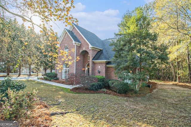 1418 Brighton Pl, Loganville, GA 30052 - view of front of property featuring brick siding, roof with shingles, and a front lawn