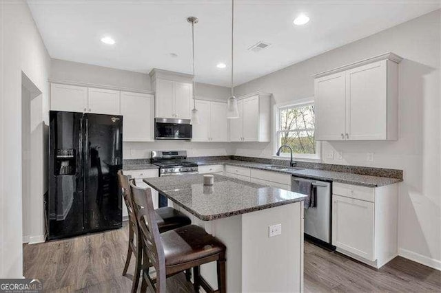 822 Pine Way, Dallas, GA 30157 - kitchen featuring appliances with stainless steel finishes, wood finished floors, white cabinetry, and recessed lighting
