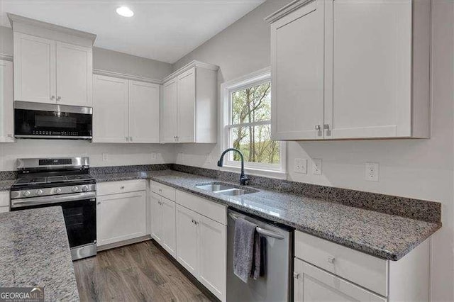 822 Pine Way, Dallas, GA 30157 - kitchen with appliances with stainless steel finishes, white cabinetry, dark wood-style floors, stone countertops, and recessed lighting