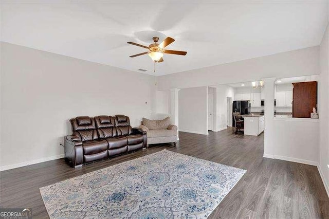 822 Pine Way, Dallas, GA 30157 - living room with a ceiling fan, ornate columns, and dark wood-style flooring