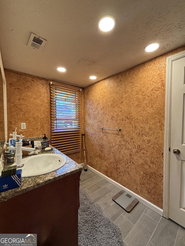 2220 Wellington Cir, Lithonia, GA 30058 - bathroom featuring vanity, wood finish floors, visible vents, and recessed lighting