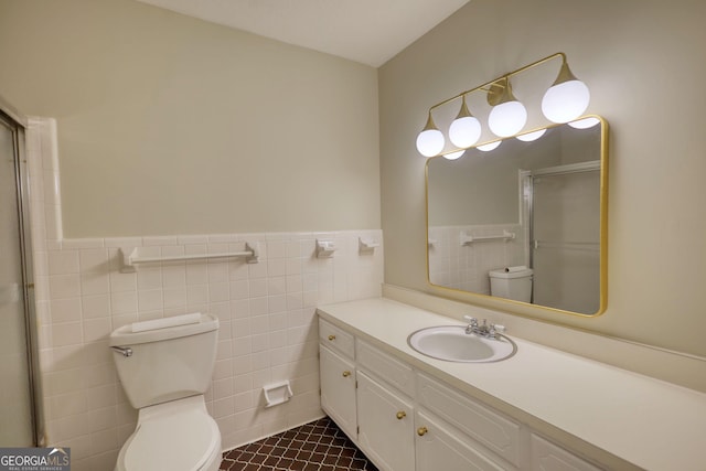 full bath featuring tile walls, toilet, an enclosed shower, wainscoting, and tile patterned flooring