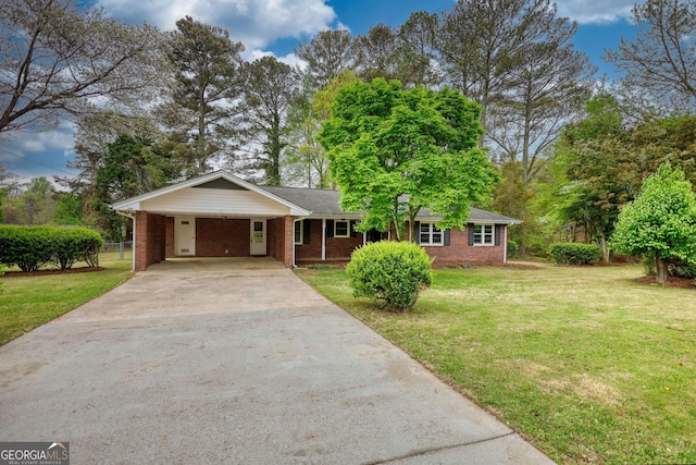 ranch-style house featuring a front yard, brick siding, an attached carport, and concrete driveway