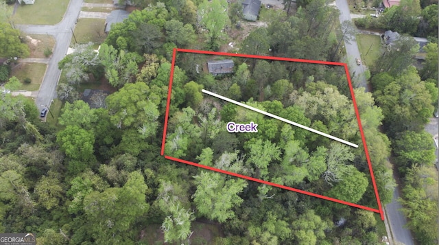 birds eye view of property with a view of trees