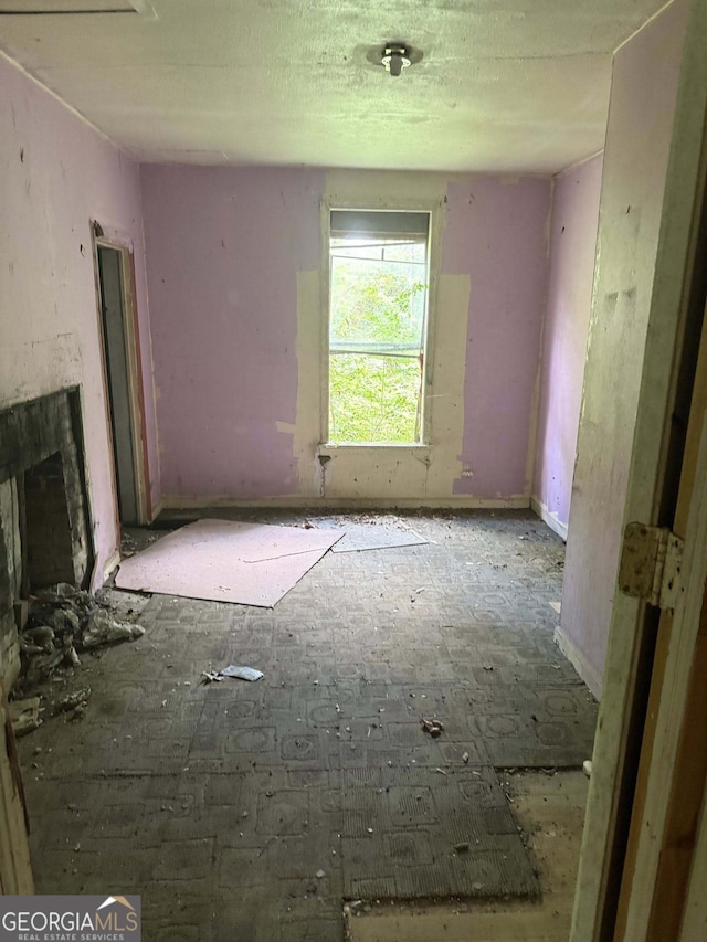 unfurnished living room with a fireplace