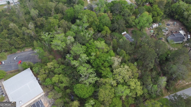 drone / aerial view with a wooded view
