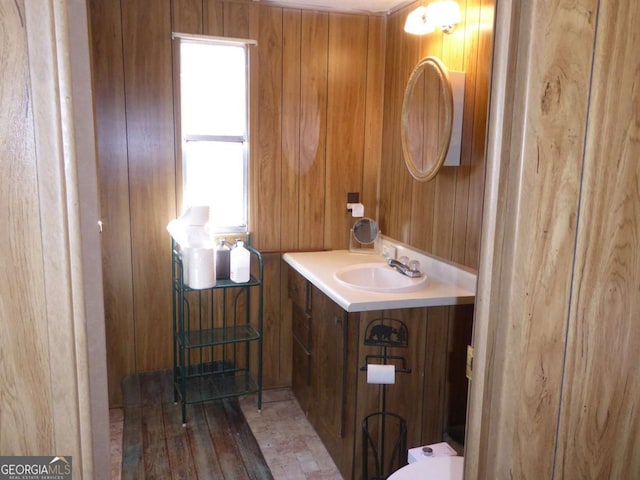 1467 Creek Rd, Hiawassee, GA 30546 - half bath with vanity, wooden walls, and wood finished floors