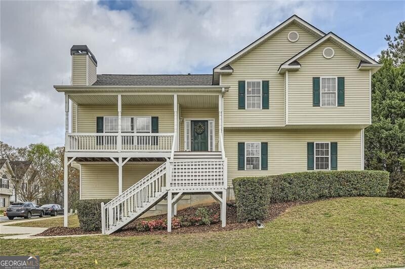 5997 Tate Dr, Austell, GA 30106 - view of front facade featuring a front yard, a shingled roof, a porch, a chimney, and stairway