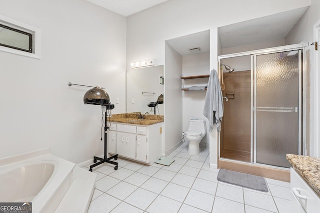 full bath with vanity, toilet, a stall shower, and tile patterned floors