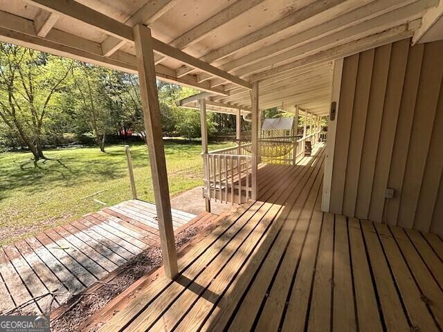 wooden deck with a lawn