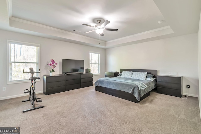 carpeted bedroom with a raised ceiling, crown molding, baseboards, and visible vents