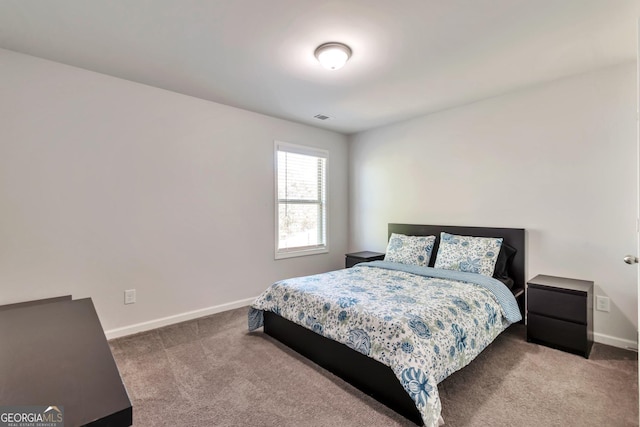 carpeted bedroom with visible vents and baseboards