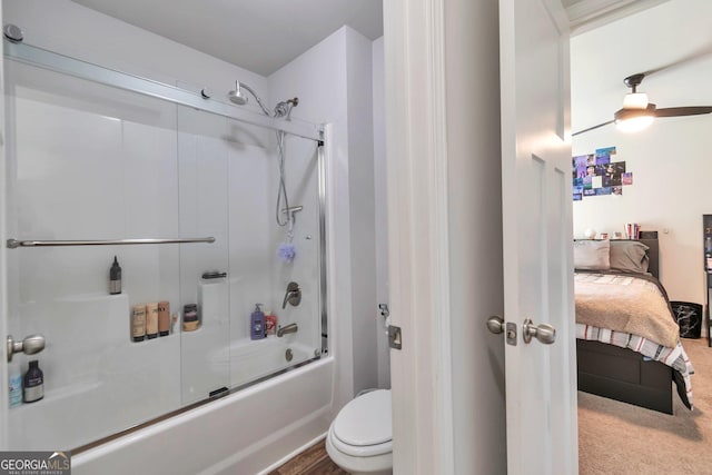 full bathroom with combined bath / shower with glass door, toilet, and ensuite bath