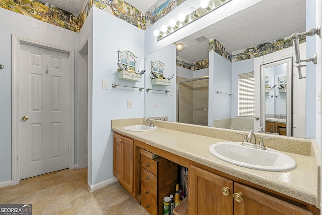 bathroom featuring a sink, a shower stall, and double vanity