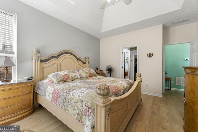 bedroom with baseboards, a ceiling fan, light wood-style floors, and visible vents