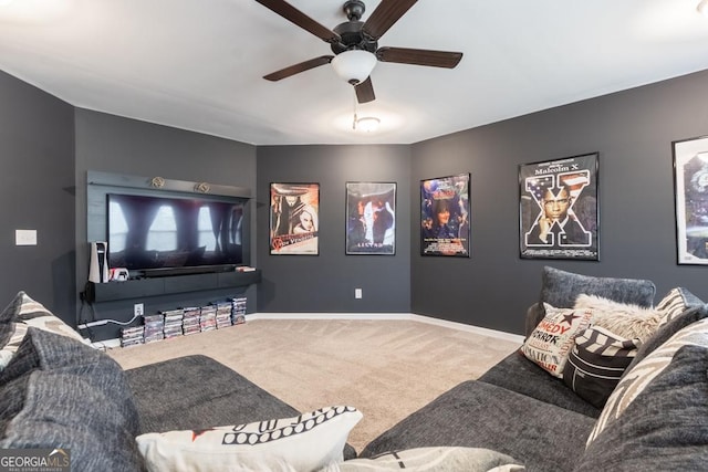 cinema room featuring carpet floors, baseboards, and a ceiling fan