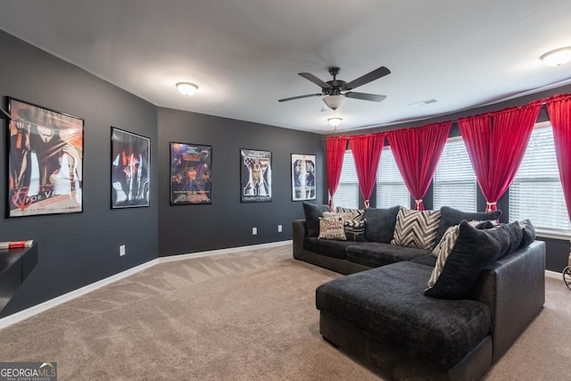 carpeted living room with visible vents, baseboards, and ceiling fan