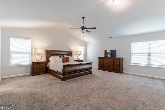 bedroom featuring baseboards, multiple windows, and vaulted ceiling
