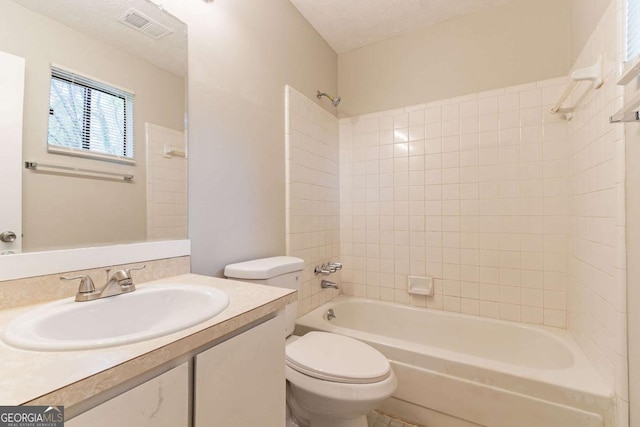 bathroom with visible vents, toilet, a textured ceiling, vanity, and shower / bathtub combination