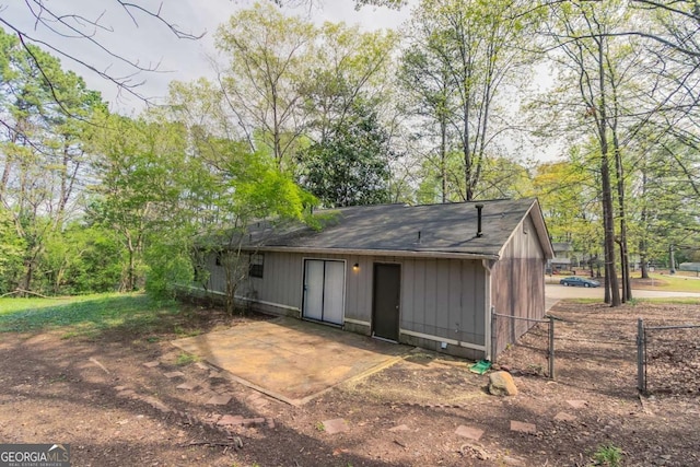 rear view of property featuring fence