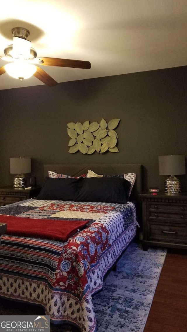 bedroom with a ceiling fan and wood finished floors
