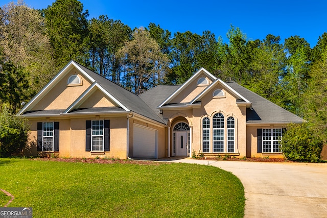 230 Hidden Brook Trl, Fayetteville, GA 30215 - view of front facade featuring stucco siding, a front yard, an attached garage, and driveway