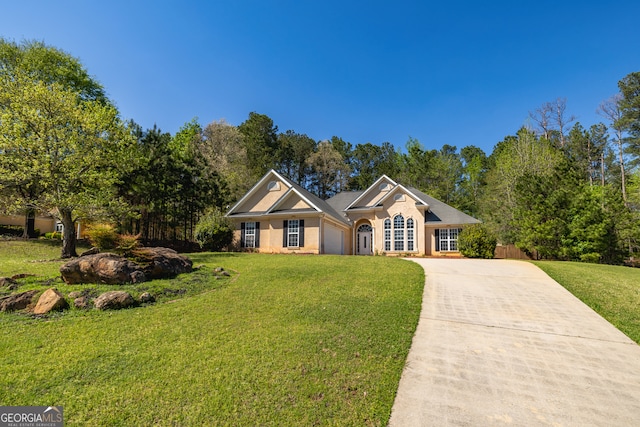 230 Hidden Brook Trl, Fayetteville, GA 30215 - view of front of home featuring concrete driveway, a front lawn, and an attached garage