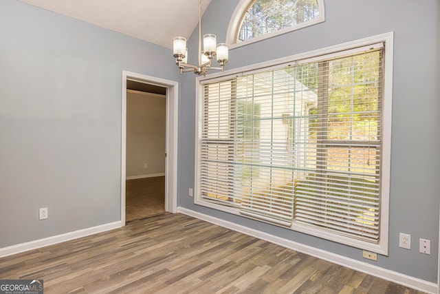 230 Hidden Brook Trl, Fayetteville, GA 30215 - unfurnished dining area with a chandelier, baseboards, and wood finished floors