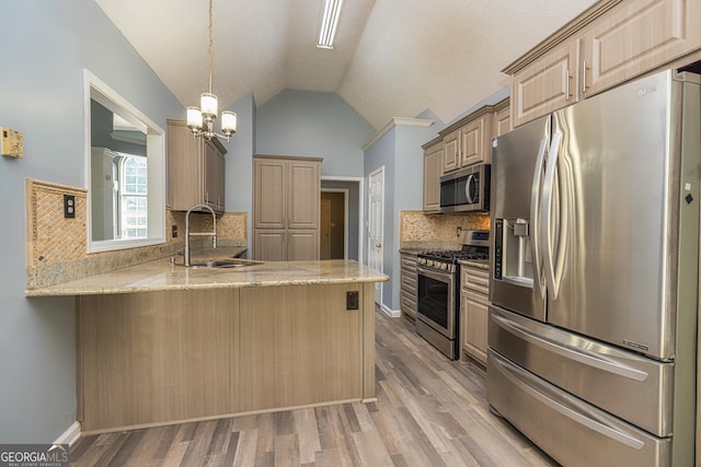230 Hidden Brook Trl, Fayetteville, GA 30215 - kitchen with appliances with stainless steel finishes, a sink, a peninsula, lofted ceiling, and a chandelier